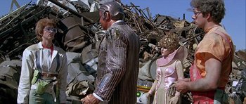 Movie still from “Heartbeeps” (1981), directed by Allan Arkush – A man and a woman standing next to a pile of rubble; Medium shot, Low angle