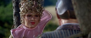 Movie still from “Heartbeeps” (1981), directed by Allan Arkush – A woman in a pink shirt is looking at a man in a striped shirt; Close Up shot, Over the shoulder angle