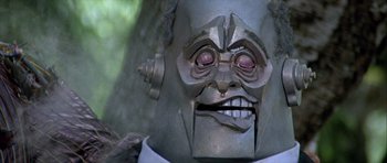 Movie still from “Heartbeeps” (1981), directed by Allan Arkush – The face of an iron man mask; Extreme Close Up shot, Low angle
