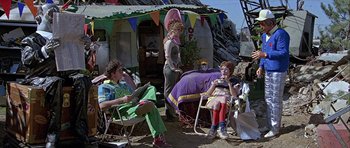 Movie still from “Heartbeeps” (1981), directed by Allan Arkush – A group of people sitting in lawn chairs outside; Wide shot, Low angle
