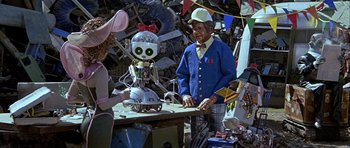 Movie still from “Heartbeeps” (1981), directed by Allan Arkush – A man and a woman standing in front of a robot; Medium shot, Over the shoulder angle