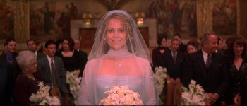 Movie still from “Heartbreakers” (2001), directed by David Mirkin – A woman in a wedding dress holding a bouquet of flowers; Close Up shot, Overhead angle