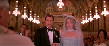 Movie still from “Heartbreakers” (2001), directed by David Mirkin – A man and a woman standing in front of a chandelier; Medium shot, Low angle