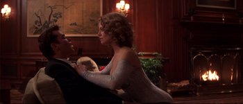 Movie still from “Heartbreakers” (2001), directed by David Mirkin – A man and woman sitting at a dinner table; Medium shot, Over the shoulder angle