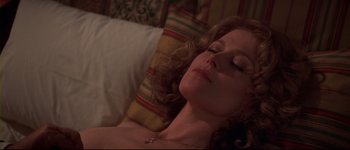 Movie still from “Heartbreakers” (2001), directed by David Mirkin – A woman laying on top of a bed next to pillows; Close Up shot, Overhead angle