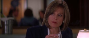 Movie still from “Heartbreakers” (2001), directed by David Mirkin – A person holding a glass of wine; Close Up shot, Over the shoulder angle