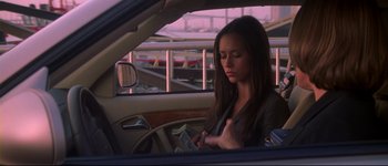 Movie still from “Heartbreakers” (2001), directed by David Mirkin – A woman sitting in the passenger seat of a car; Medium shot, Low angle