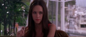 Movie still from “Heartbreakers” (2001), directed by David Mirkin – A woman with long hair sitting in a chair; Close Up shot, Over the shoulder angle