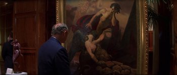 Movie still from “Heartbreakers” (2001), directed by David Mirkin – A man standing in front of a painting; Medium shot, Over the shoulder angle