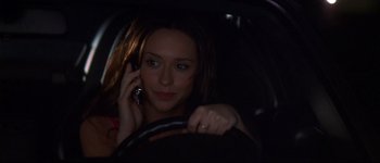 Movie still from “Heartbreakers” (2001), directed by David Mirkin – A woman driving a car while talking on a cell phone; Close Up shot, Over the shoulder angle