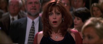 Movie still from “Heartbreakers” (2001), directed by David Mirkin – A person wearing a suit and tie; Close Up shot, Over the shoulder angle