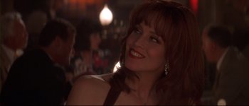Movie still from “Heartbreakers” (2001), directed by David Mirkin – A person smiling at a party; Close Up shot, Over the shoulder angle