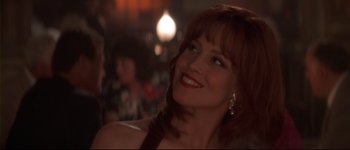 Movie still from “Heartbreakers” (2001), directed by David Mirkin – A person smiling at a party; Close Up shot, Over the shoulder angle