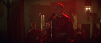 Movie still from “Heartbreakers” (2001), directed by David Mirkin – A group of people sitting in a room with microphones; Medium shot, Low angle