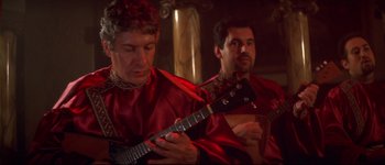 Movie still from “Heartbreakers” (2001), directed by David Mirkin – A couple of people that are playing a guitar; Close Up shot, Low angle