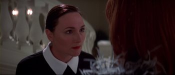 Movie still from “Heartbreakers” (2001), directed by David Mirkin – A woman is looking at her reflection in the mirror; Close Up shot, Over the shoulder angle