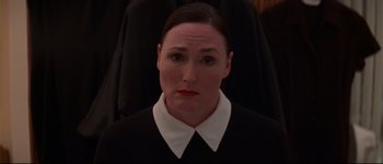 Movie still from “Heartbreakers” (2001), directed by David Mirkin – A woman in a white shirt and a black jacket; Close Up shot, Low angle