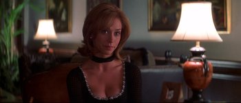 Movie still from “Heartbreakers” (2001), directed by David Mirkin – A woman in a black dress and a black necklace; Close Up shot, Over the shoulder angle