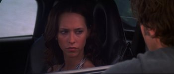 Movie still from “Heartbreakers” (2001), directed by David Mirkin – A woman sitting in the driver's seat of a car; Close Up shot, Over the shoulder angle