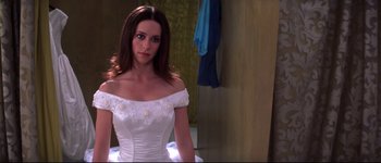 Movie still from “Heartbreakers” (2001), directed by David Mirkin – A woman in a white dress in front of a mirror; Medium shot, Over the shoulder angle