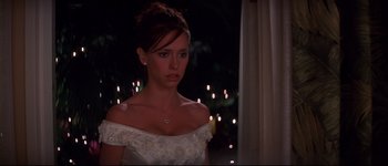 Movie still from “Heartbreakers” (2001), directed by David Mirkin – A beautiful young lady wearing a white dress; Close Up shot, Over the shoulder angle