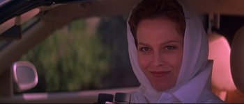 Movie still from “Heartbreakers” (2001), directed by David Mirkin – A person in a car wearing a headscarf; Close Up shot, Low angle