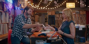 Movie still from “Hearts Beat Loud” (2018), directed by Brett Haley – A man and a woman sitting at a wooden table; Medium shot, Over the shoulder angle