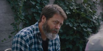 Movie still from “Hearts Beat Loud” (2018), directed by Brett Haley – A man with a gray beard is sitting in front of some bushes; Close Up shot, Over the shoulder angle