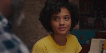 Movie still from “Hearts Beat Loud” (2018), directed by Brett Haley – A young woman in a yellow t - shirt looks at the camera; Close Up shot, Over the shoulder angle