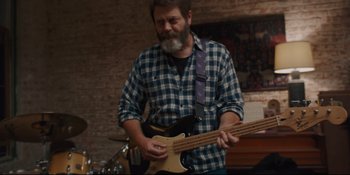 Movie still from “Hearts Beat Loud” (2018), directed by Brett Haley – A bearded man playing a bass guitar in a room; Medium shot, Low angle