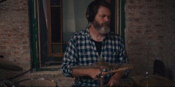 Movie still from “Hearts Beat Loud” (2018), directed by Brett Haley – A man with a beard wearing headphones playing drums; Close Up shot, Over the shoulder angle