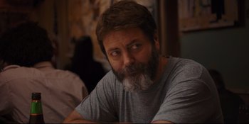 Movie still from “Hearts Beat Loud” (2018), directed by Brett Haley – A man with a beard sitting at a table; Close Up shot, Over the shoulder angle