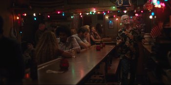 Movie still from “Hearts Beat Loud” (2018), directed by Brett Haley – A group of people sitting at a long table; Wide shot, Low angle