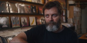 Movie still from “Hearts Beat Loud” (2018), directed by Brett Haley – A man with a long beard and a black t - shirt; Close Up shot, Over the shoulder angle