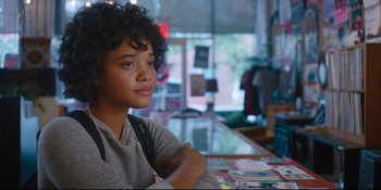 Movie still from “Hearts Beat Loud” (2018), directed by Brett Haley – A young woman sitting at a table in front of a window; Close Up shot, Over the shoulder angle