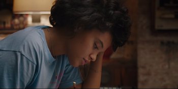 Movie still from “Hearts Beat Loud” (2018), directed by Brett Haley – A woman sitting in front of a table with her head resting on her hand; Close Up shot, High angle