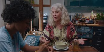 Movie still from “Hearts Beat Loud” (2018), directed by Brett Haley – A woman sitting at a table with a bowl of soup; Medium shot, Over the shoulder angle