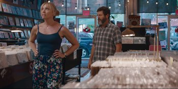 Movie still from “Hearts Beat Loud” (2018), directed by Brett Haley – A man and a woman standing next to each other in a store; Medium shot, Over the shoulder angle