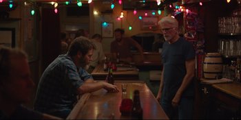 Movie still from “Hearts Beat Loud” (2018), directed by Brett Haley – Two men sitting at a table in front of a bottle of beer; Wide shot, Over the shoulder angle