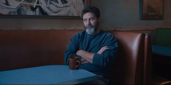 Movie still from “Hearts Beat Loud” (2018), directed by Brett Haley – A man sitting at a table with his arms crossed; Medium shot, Low angle