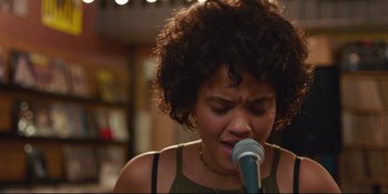 Movie still from “Hearts Beat Loud” (2018), directed by Brett Haley – A woman with curly hair singing into a microphone; Close Up shot, Low angle