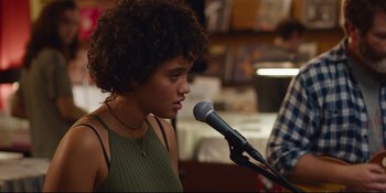 Movie still from “Hearts Beat Loud” (2018), directed by Brett Haley – A young woman holding a microphone in front of a man; Close Up shot, Over the shoulder angle