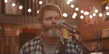 Movie still from “Hearts Beat Loud” (2018), directed by Brett Haley – A man with a beard is singing into a microphone; Close Up shot, Over the shoulder angle