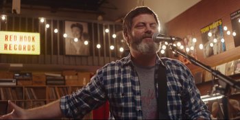 Movie still from “Hearts Beat Loud” (2018), directed by Brett Haley – A man with a beard is singing into a microphone; Medium shot, Low angle