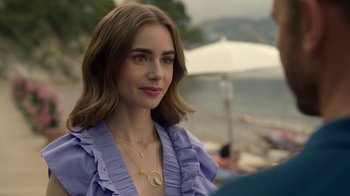 Movie still from “Emily in Paris” (2020), created by Darren Star – A person wearing a necklace; Close Up shot, Over the shoulder angle