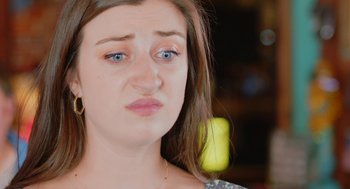 Movie still from “Heaven's Date” (2022), directed by Stevie Fernandez – A person looking sad; Close Up shot, Over the shoulder angle
