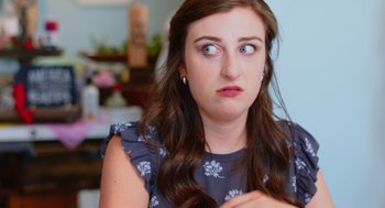 Movie still from “Heaven's Date” (2022), directed by Stevie Fernandez – A person with long brown hair looking at the camera; Close Up shot, Over the shoulder angle