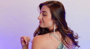Movie still from “Heaven's Date” (2022), directed by Stevie Fernandez – A beautiful young lady with long brown wavy hair; Close Up shot, Low angle