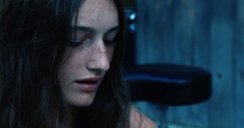 Movie still from “Hellbender” (2021), directed by Zelda Adams – A person with long hair; Close Up shot, High angle