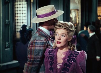 Movie still from “Hello Frisco, Hello” (1943), directed by H. Bruce Humberstone – A man and a woman standing next to each other; Medium shot, Over the shoulder angle